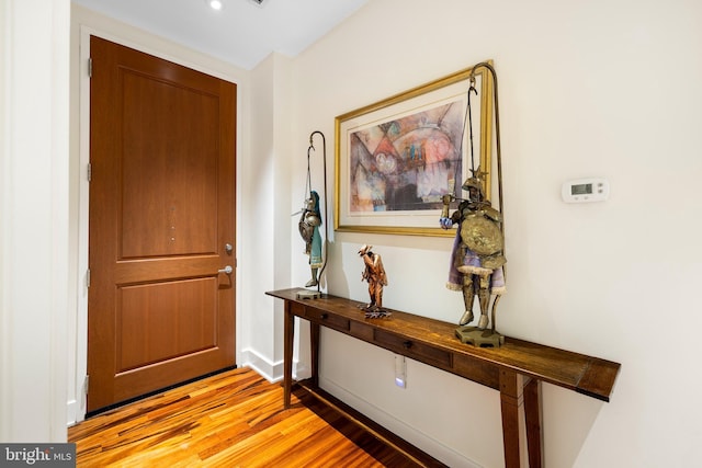 entryway with baseboards and light wood-style flooring