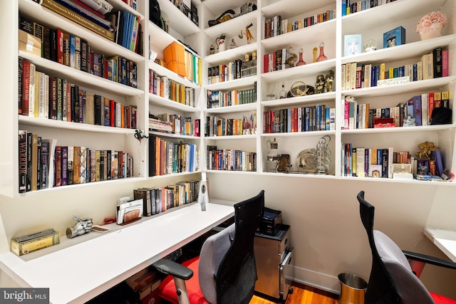 home office with hardwood / wood-style flooring