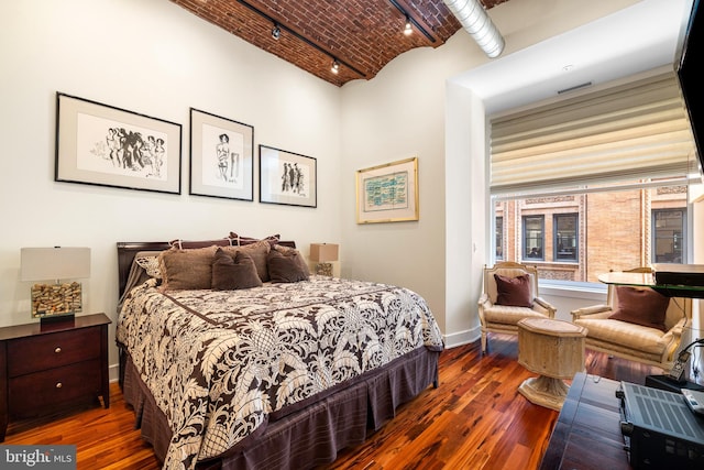 bedroom with dark wood-type flooring