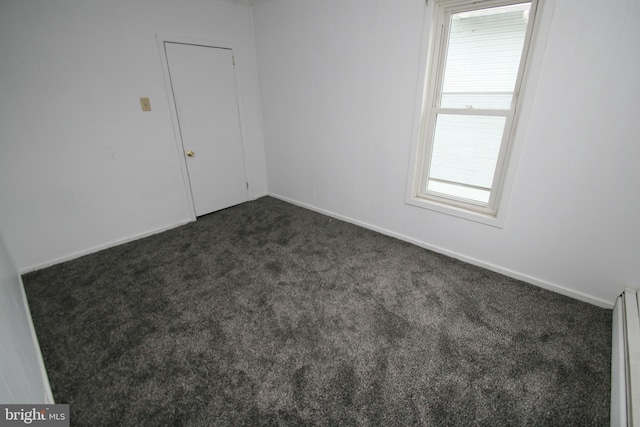 361 Ridgley, Orbisonia, PA 17243 - unfurnished room featuring dark carpet and a baseboard heating unit