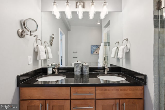 bathroom with vanity and a shower with shower door