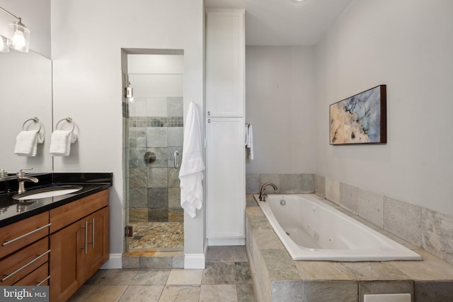 bathroom featuring shower with separate bathtub and vanity