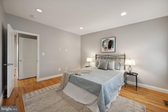 bedroom with hardwood / wood-style flooring