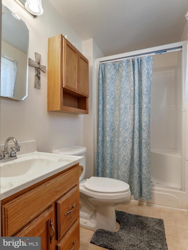 bathroom with tile patterned floors, toilet, walk in shower, and vanity