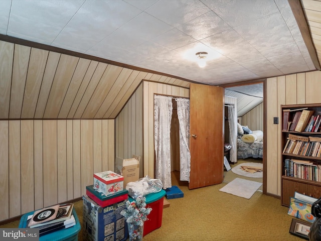 bonus room featuring wood walls, carpet flooring, and vaulted ceiling