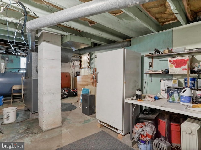 basement featuring white fridge