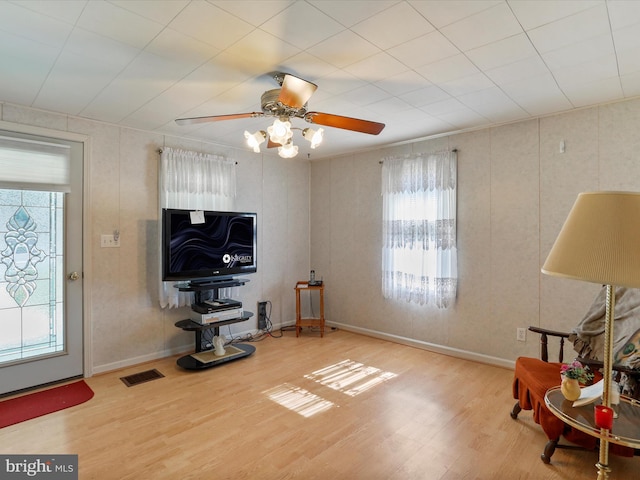 sitting room with hardwood / wood-style flooring and ceiling fan