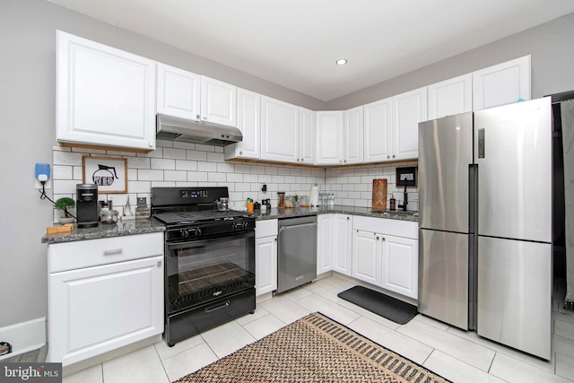 kitchen featuring white cabinets, light tile patterned floors, tasteful backsplash, appliances with stainless steel finishes, and dark stone counters