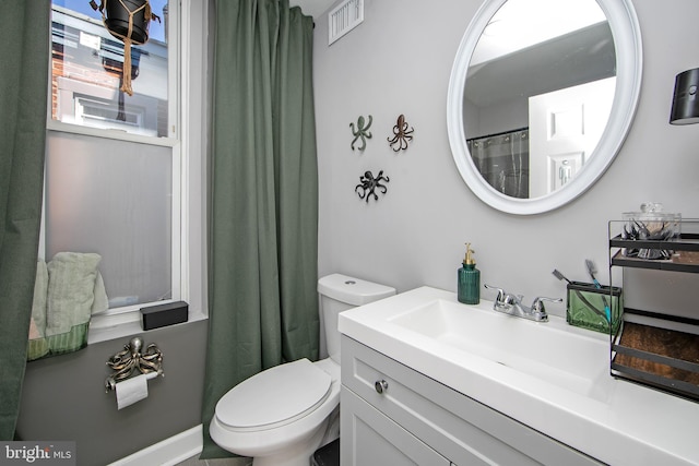 bathroom with vanity, toilet, and a shower with curtain