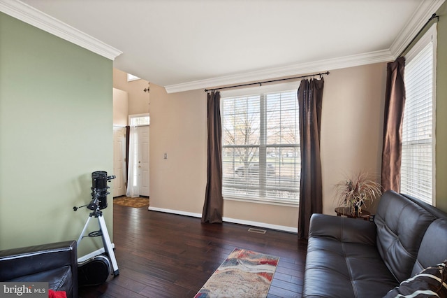 living room with dark wood-type flooring and ornamental molding