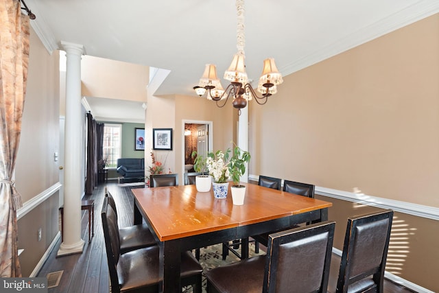 dining area with decorative columns, a notable chandelier, dark hardwood / wood-style floors, and crown molding