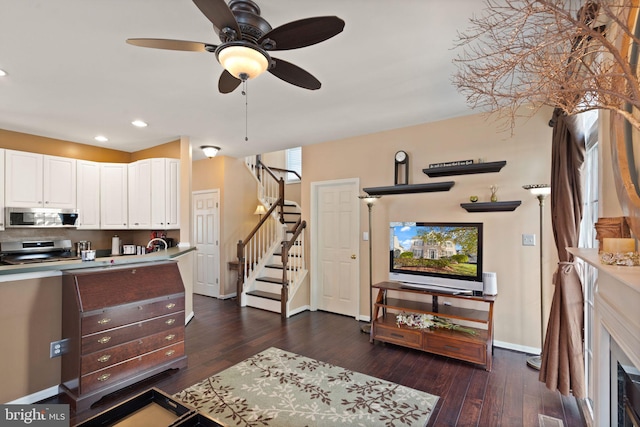 interior space featuring dark wood-type flooring, ceiling fan, and sink