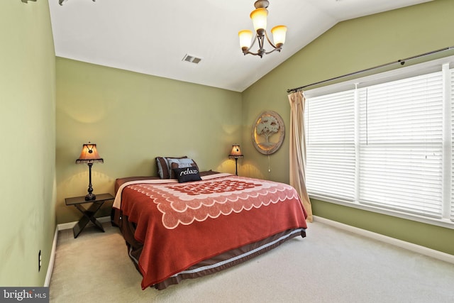 carpeted bedroom with a chandelier and vaulted ceiling