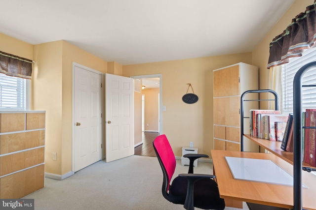 office area with plenty of natural light and light colored carpet