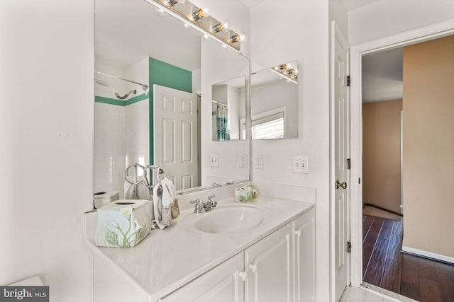 bathroom featuring walk in shower, wood-type flooring, and vanity