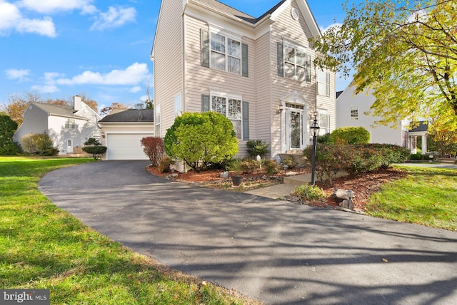 view of front of property featuring a front lawn and a garage