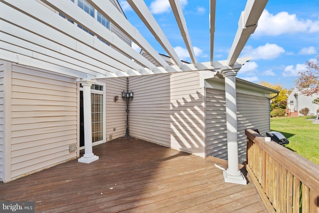 deck with a pergola and a lawn