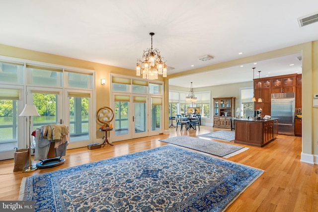 interior space with light hardwood / wood-style flooring and a chandelier