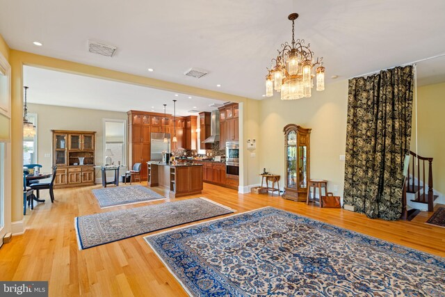 interior space featuring plenty of natural light, light wood-type flooring, and a chandelier