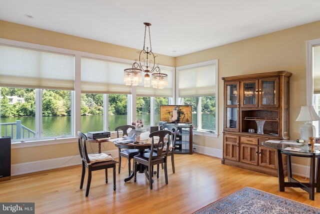 dining room featuring light hardwood / wood-style flooring and an inviting chandelier