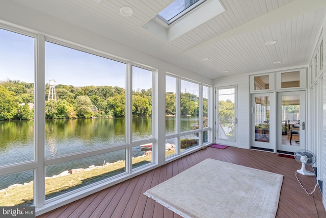 sunroom with a water view, a skylight, and a wealth of natural light