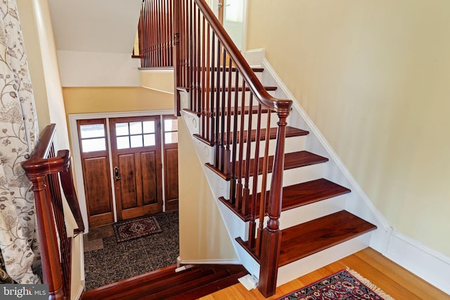 stairway with hardwood / wood-style flooring