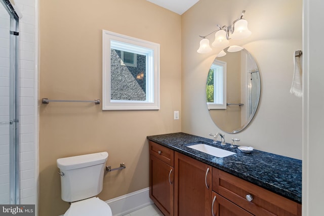 bathroom with vanity, toilet, and an enclosed shower