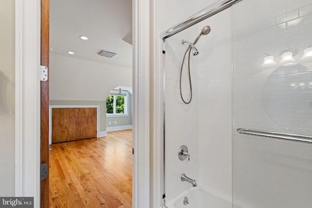 bathroom featuring shower / bath combination with glass door and hardwood / wood-style floors