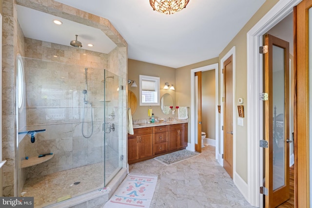 bathroom with vanity, toilet, and walk in shower