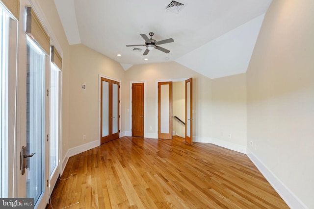 unfurnished bedroom featuring light wood-type flooring, vaulted ceiling, and ceiling fan