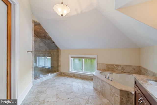 bathroom with vanity, vaulted ceiling, and independent shower and bath