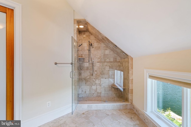 bathroom featuring lofted ceiling and walk in shower