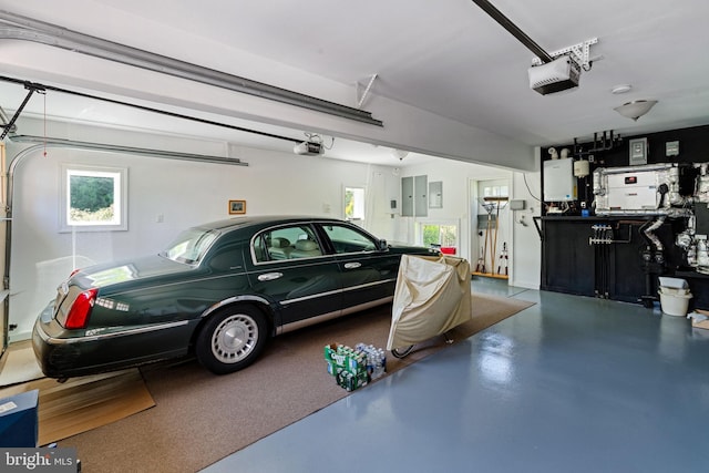 garage featuring electric panel and a garage door opener