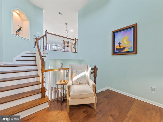 living area with a notable chandelier and hardwood / wood-style flooring