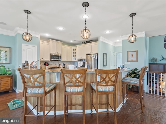 kitchen with decorative light fixtures, stainless steel appliances, and dark hardwood / wood-style floors