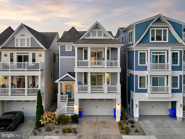 view of front of home featuring a garage and a balcony