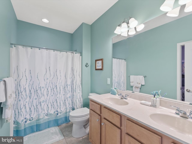 bathroom with tile patterned floors, toilet, an inviting chandelier, and vanity