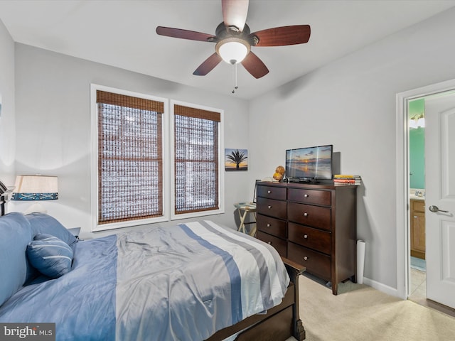 carpeted bedroom featuring connected bathroom and ceiling fan