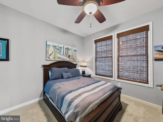 bedroom with ceiling fan and light carpet