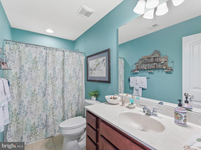 bathroom with tile patterned flooring, vanity, toilet, and walk in shower