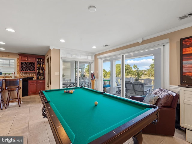 rec room with billiards, light tile patterned floors, french doors, ornamental molding, and indoor bar