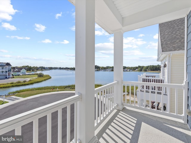 balcony featuring a water view and covered porch