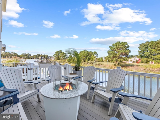 wooden terrace with an outdoor fire pit