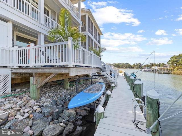 view of dock with a water view and a balcony