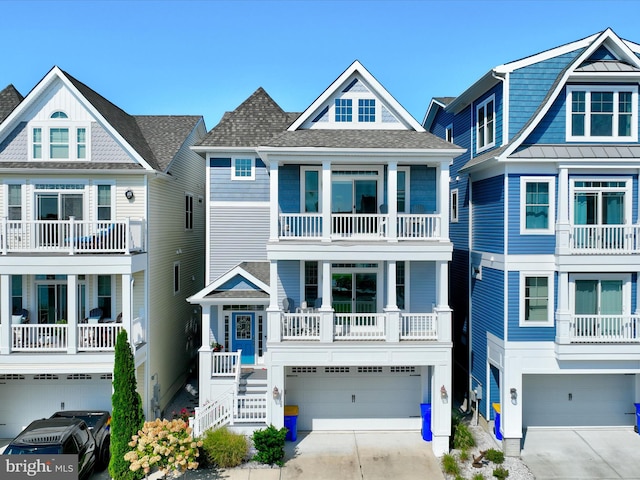 coastal inspired home with a garage and a balcony