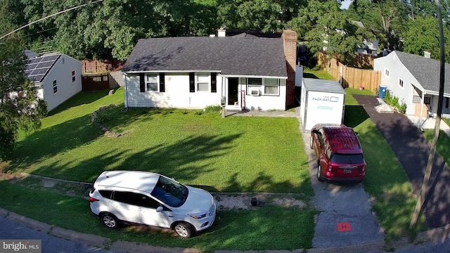 view of front facade featuring cooling unit and a front lawn