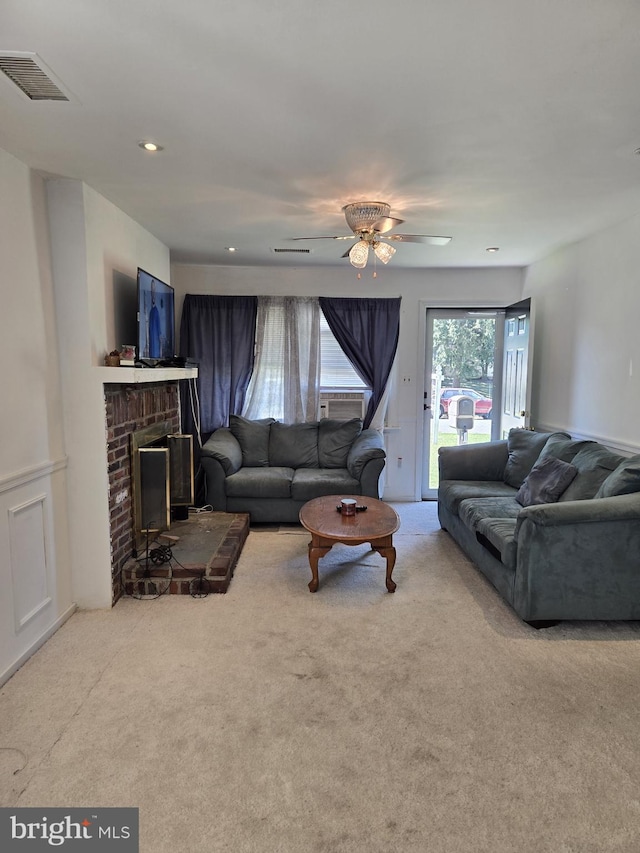 carpeted living room featuring a fireplace and ceiling fan