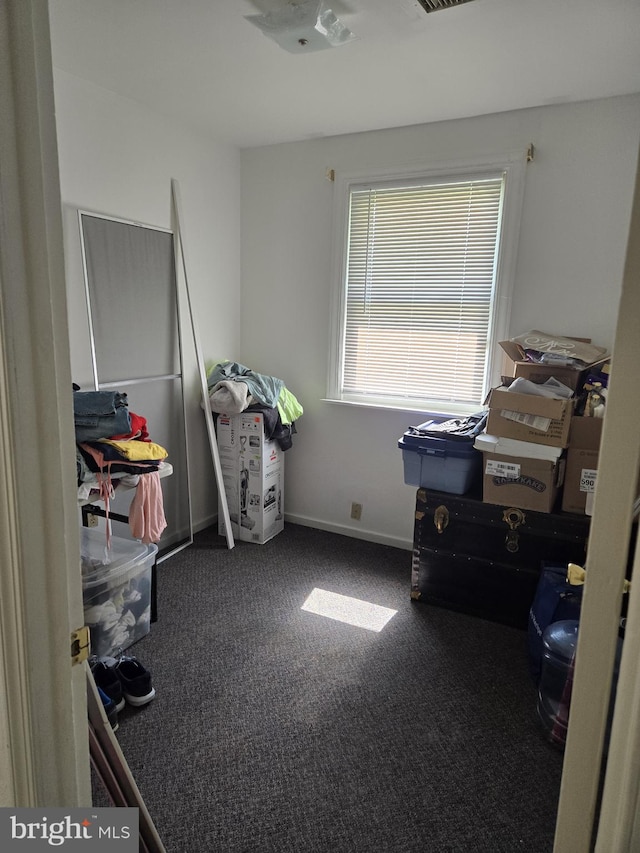 miscellaneous room with dark colored carpet