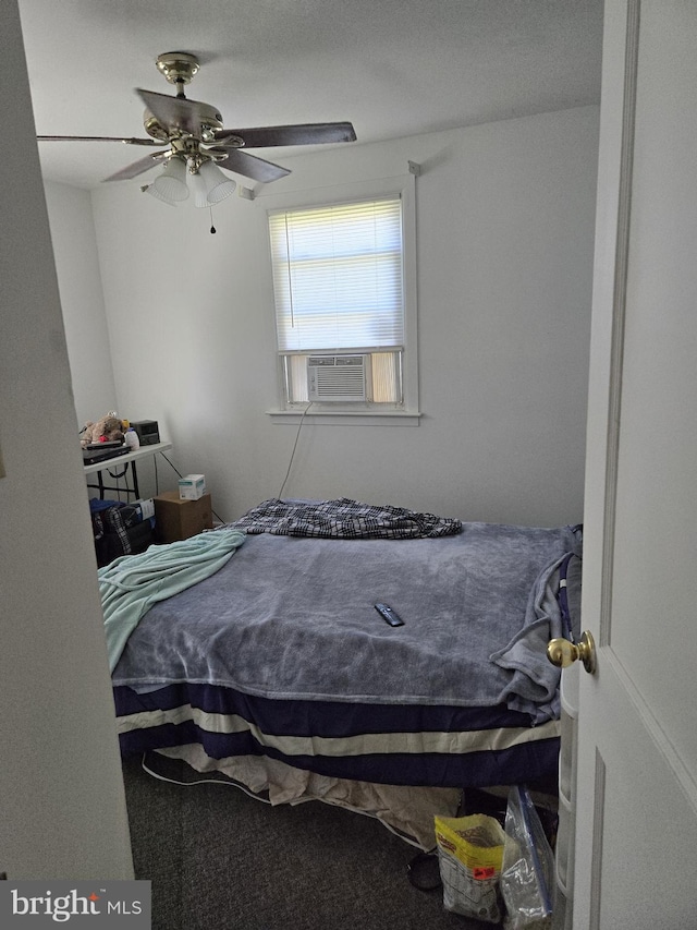 bedroom with ceiling fan, cooling unit, and carpet