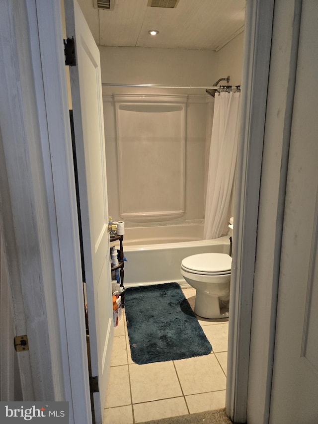 bathroom with toilet, tile patterned floors, and shower / tub combo